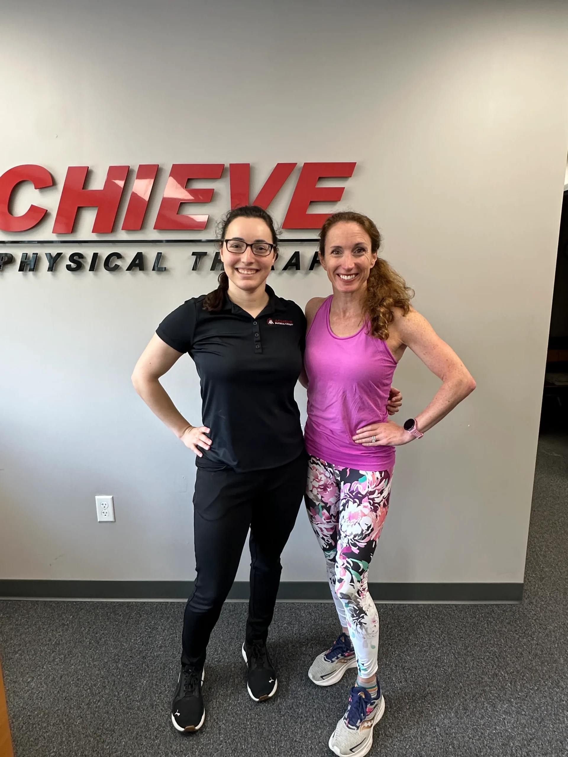 Jennifer F and Liz K, a PT at Achieve Physical Therapy, smiling after a therapy session