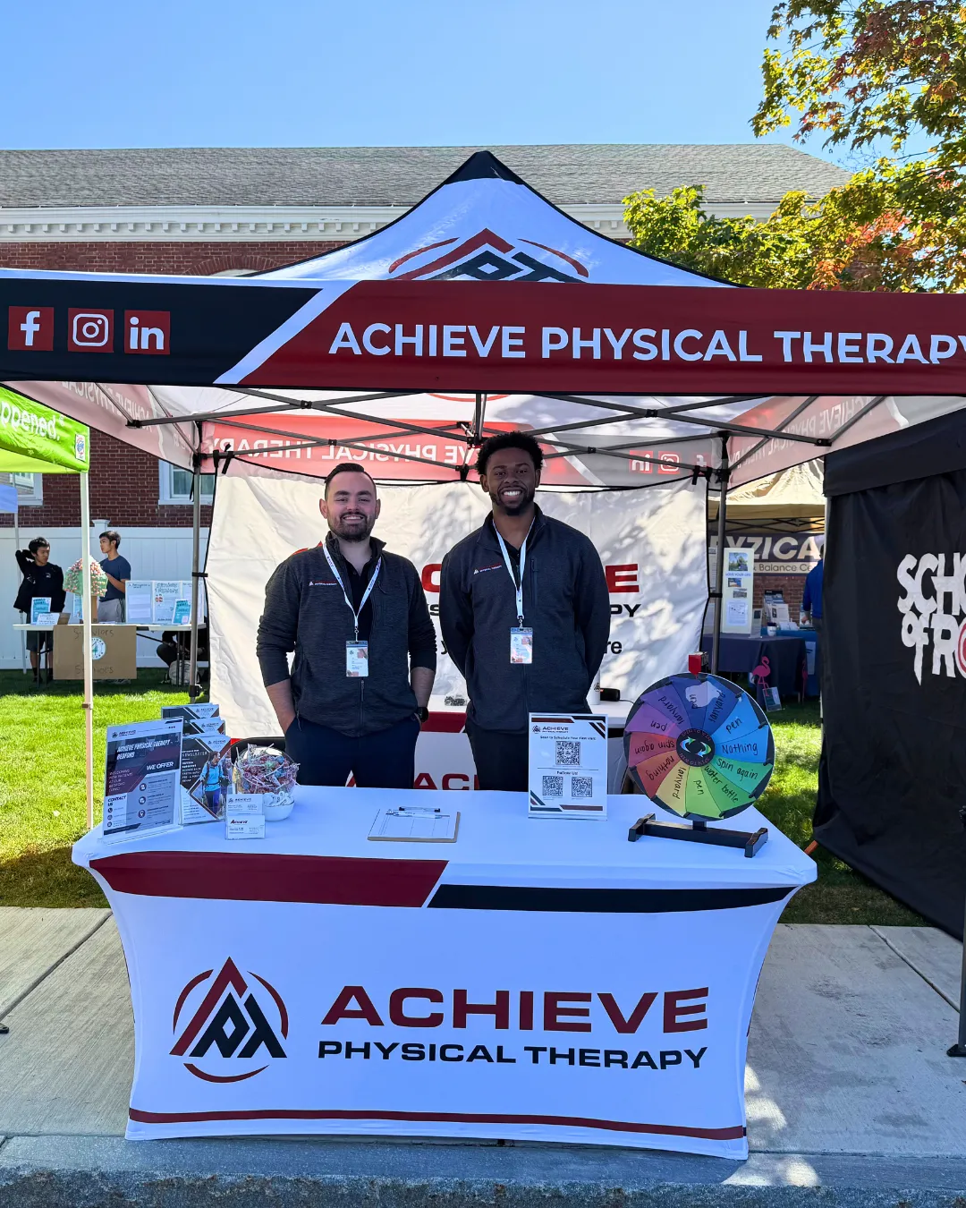 two employees from Achieve PT manning the clinic's tent during the Bedford Days event