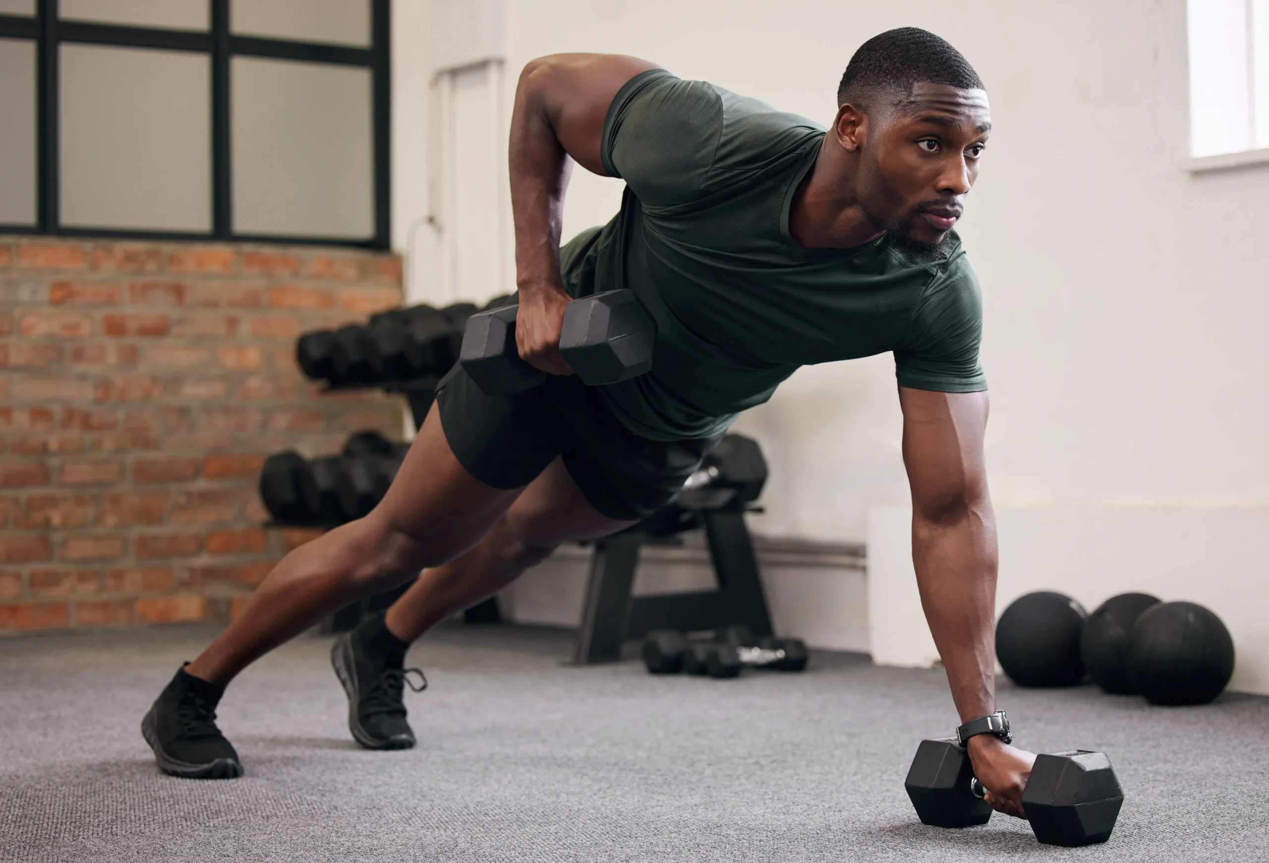 man doing a dumbbell exercise to strengthen his chest and core