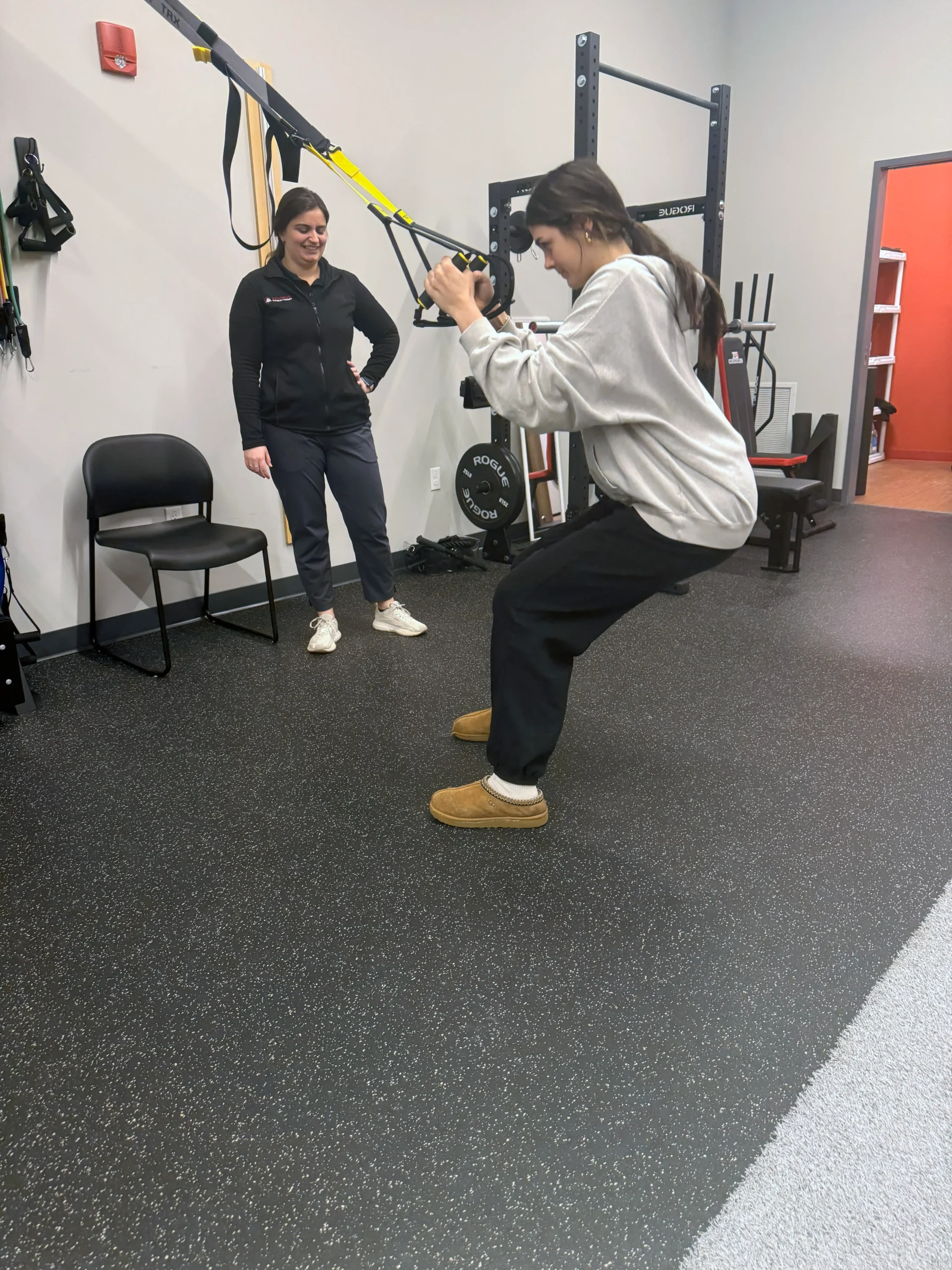 Physical therapist leading a patient through a strengthening exercise to prepare her for upcoming surgery