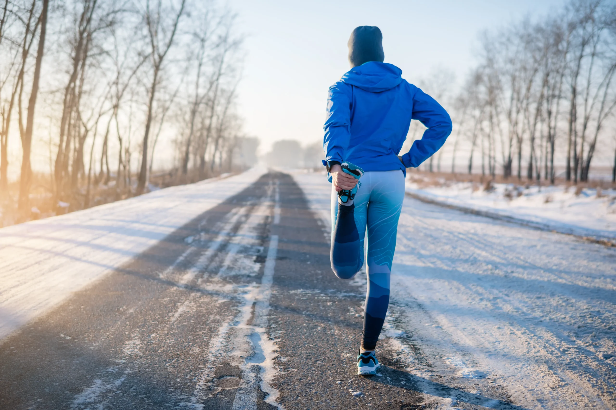 athlete stretching their hamstrings before going for a run